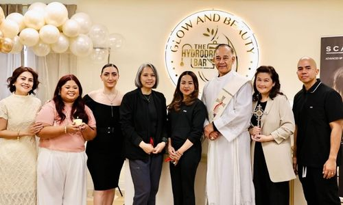 Glow and Beauty Medspa team with priest during grand opening blessing ceremony inside modern medspa clinic